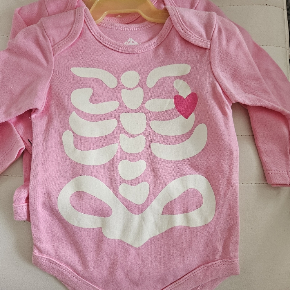 Pink onesie with heart skeleton